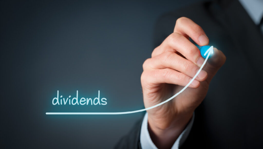 Dividends written in neon with a line under it connected to an arrow trending up.