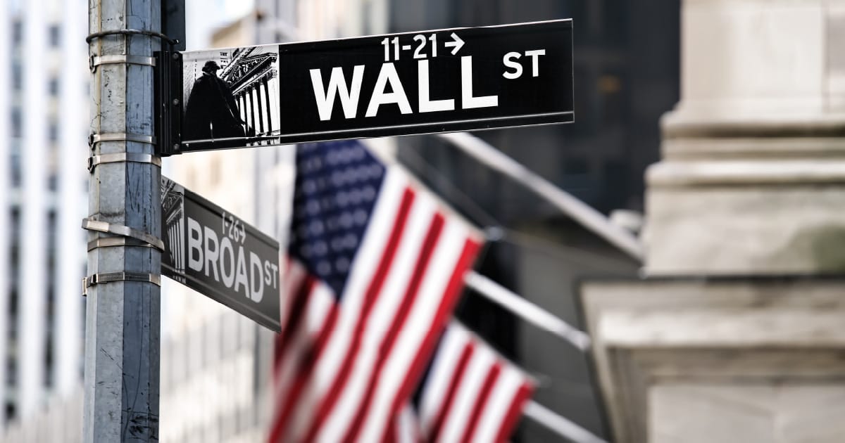 Street signs reading “Wall St” and “Broad St”
