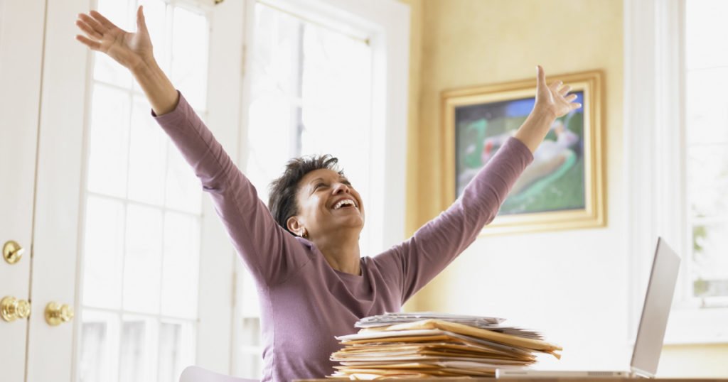 lady holding arms up happy to be debt free