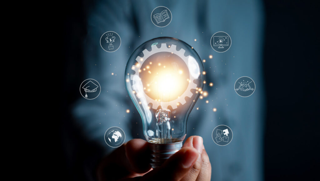 A lightbulb surrounded by icons denoting various investment sectors.